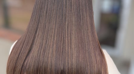 Sleek brunette hair styled at Hair By Jaimie, Melbourne, Victoria, AU, showcasing glossy, straight finish.