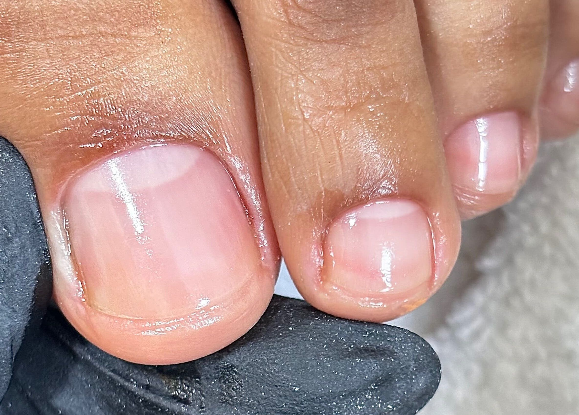 Close-up of manicured nails at Mani.festation.nbt, Mountsorrel, England, GB, showcasing glossy finish.