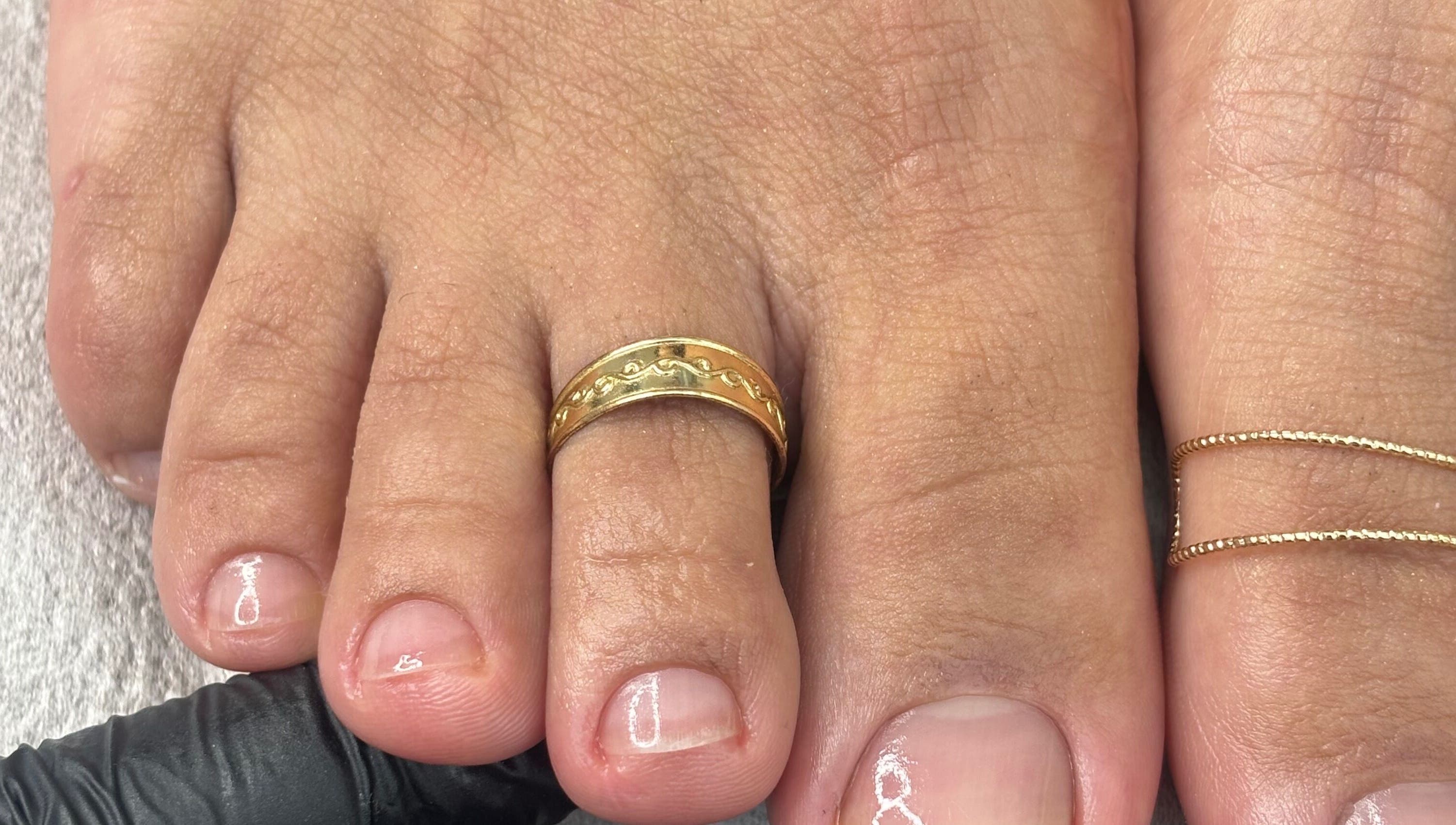 Elegant toe polish with a gold ring at Mani.festation.nbt, Mountsorrel, England, GB.