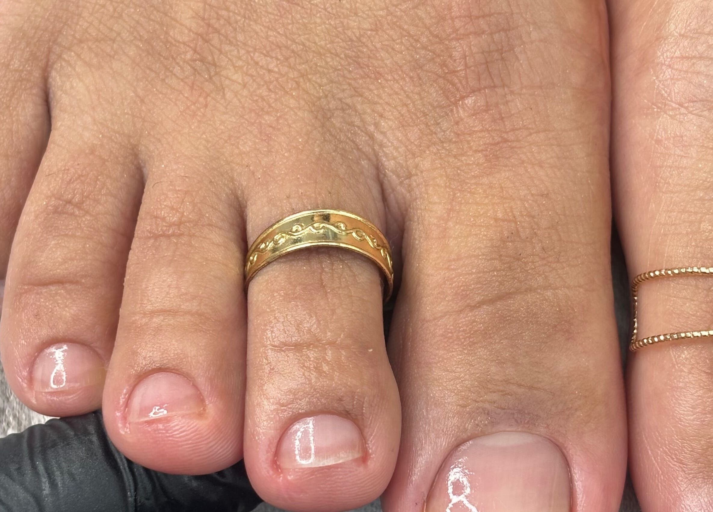 Elegant toe polish with a gold ring at Mani.festation.nbt, Mountsorrel, England, GB.