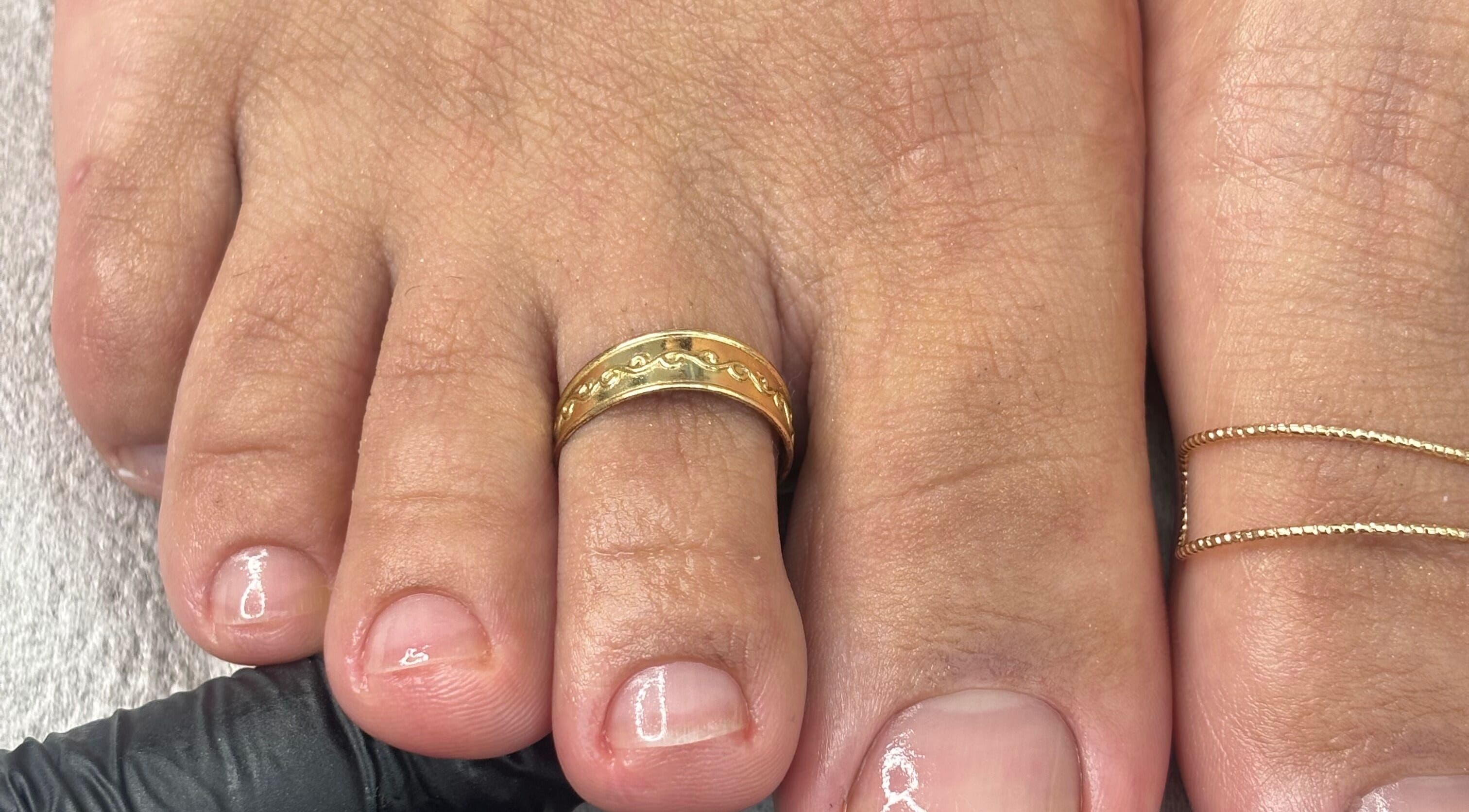 Elegant toe polish with a gold ring at Mani.festation.nbt, Mountsorrel, England, GB.