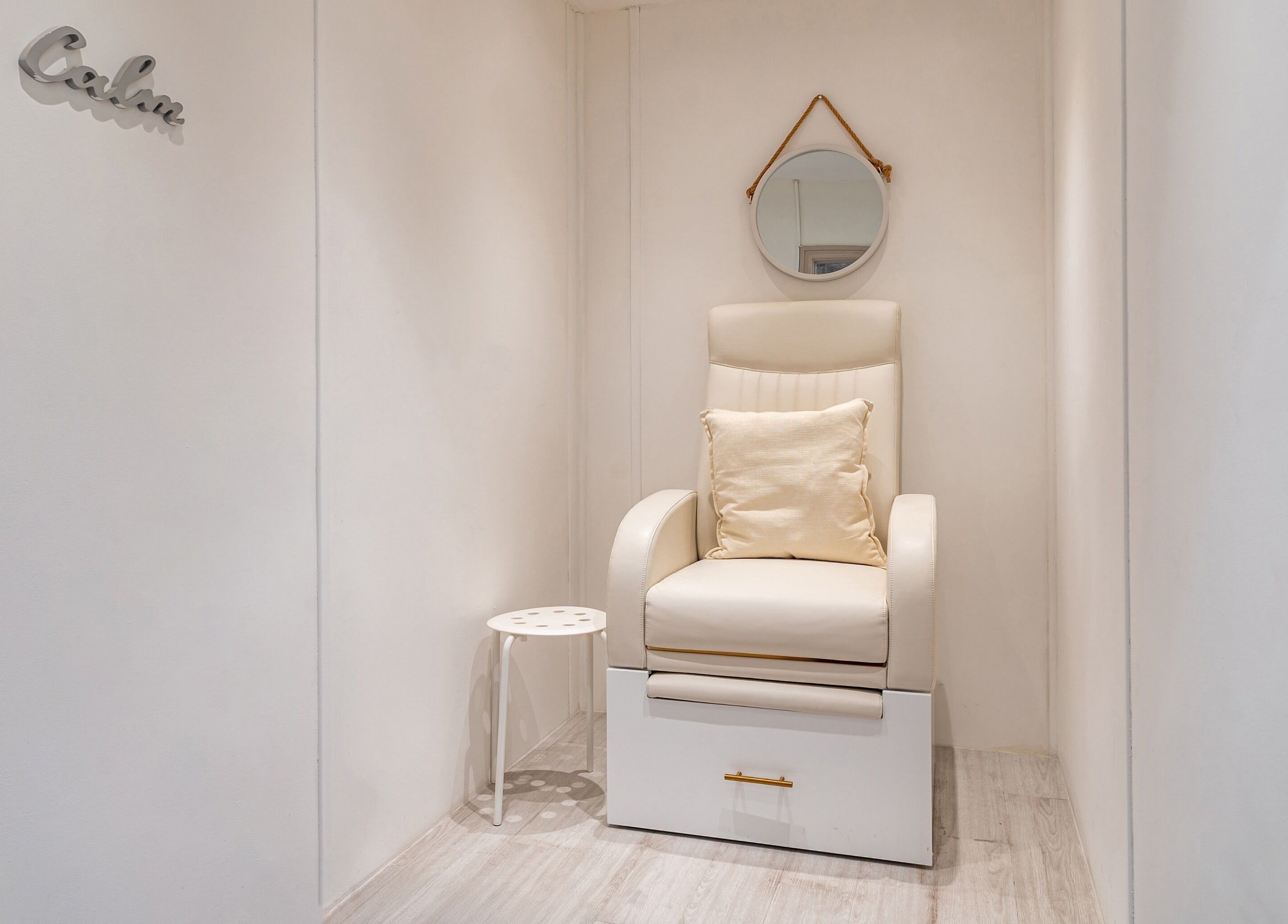 Relaxing seating area at It's Angies, London, England, GB, with a cozy beige chair and minimalist decor.