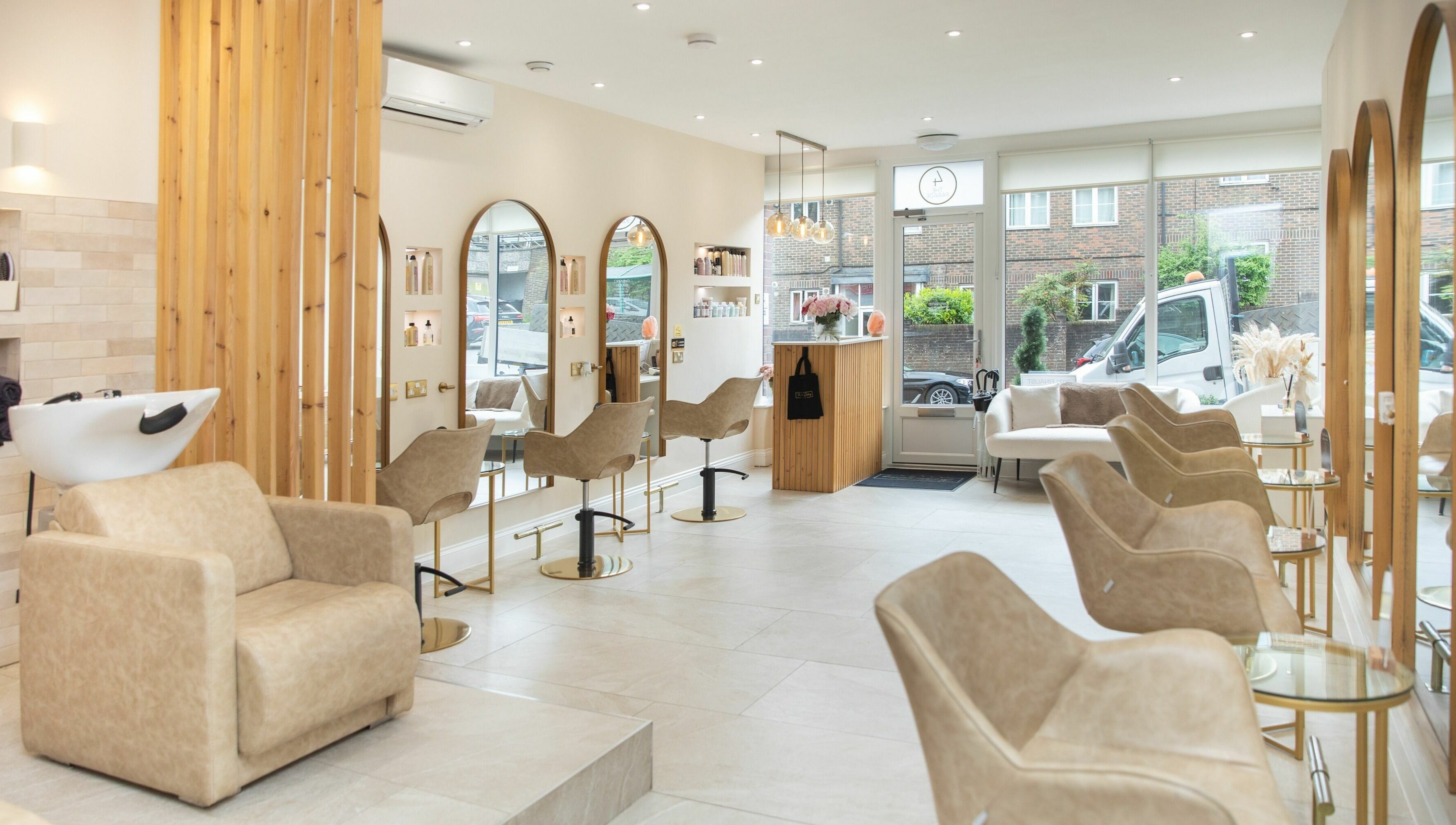 Elegant salon interior at The Colour Sanctuary in Crowborough, England featuring modern chairs and mirrors.