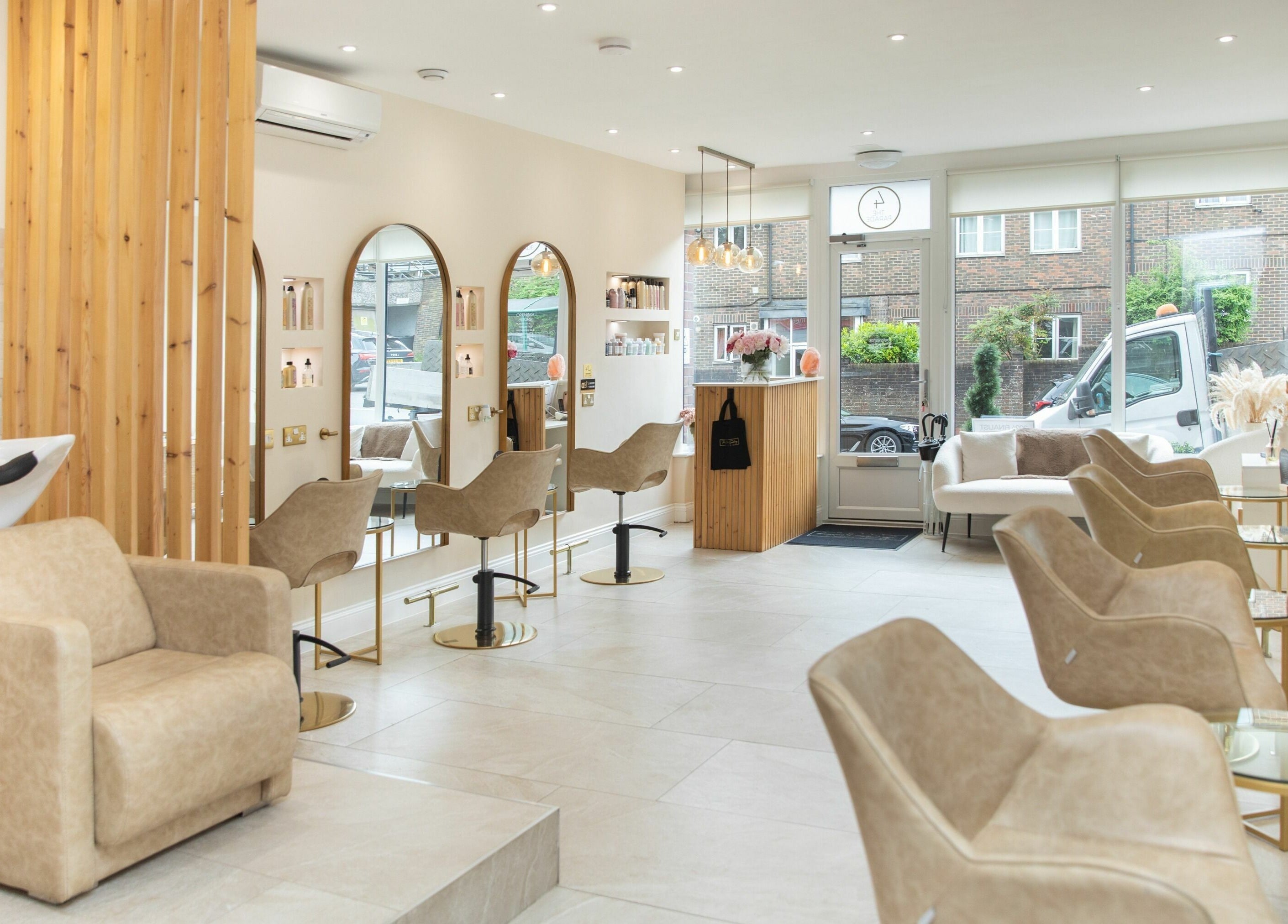 Elegant salon interior at The Colour Sanctuary in Crowborough, England featuring modern chairs and mirrors.