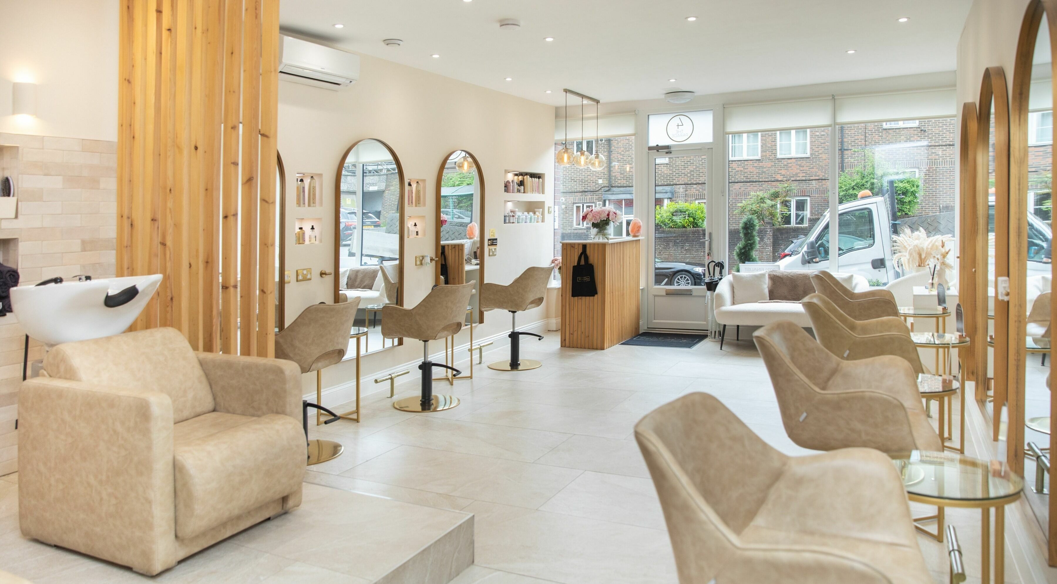 Elegant salon interior at The Colour Sanctuary in Crowborough, England featuring modern chairs and mirrors.