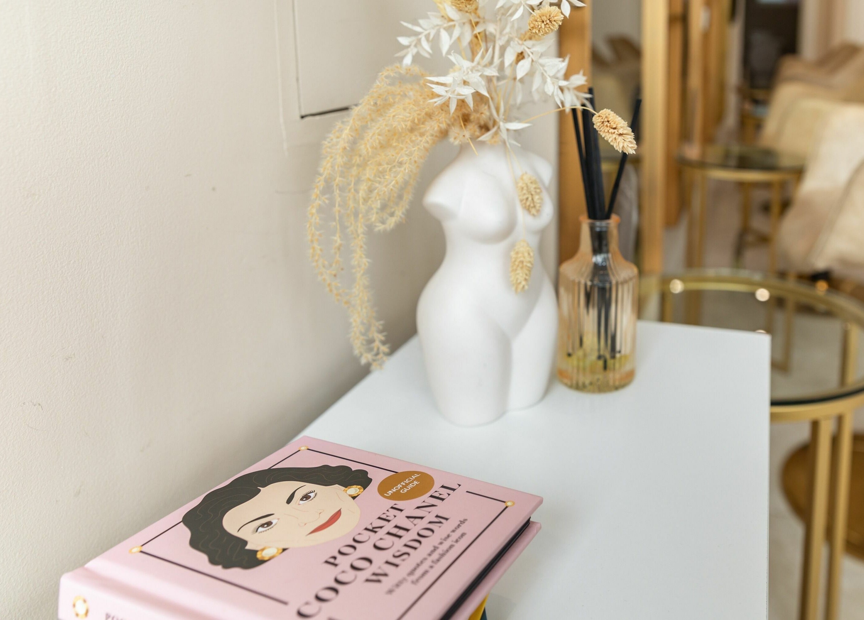 Stylish decor at The Colour Sanctuary in Crowborough, England, GB showcasing a vase and book.