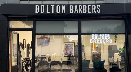 Front view of Bolton Barbers in Stirling, Scotland. Modern interior with stylish chairs and decor.