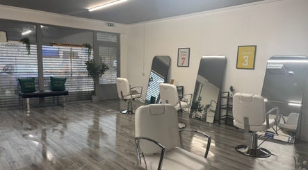 Interior of Bolton Barbers in Stirling, Scotland, GB, featuring stylish chairs and large mirrors.