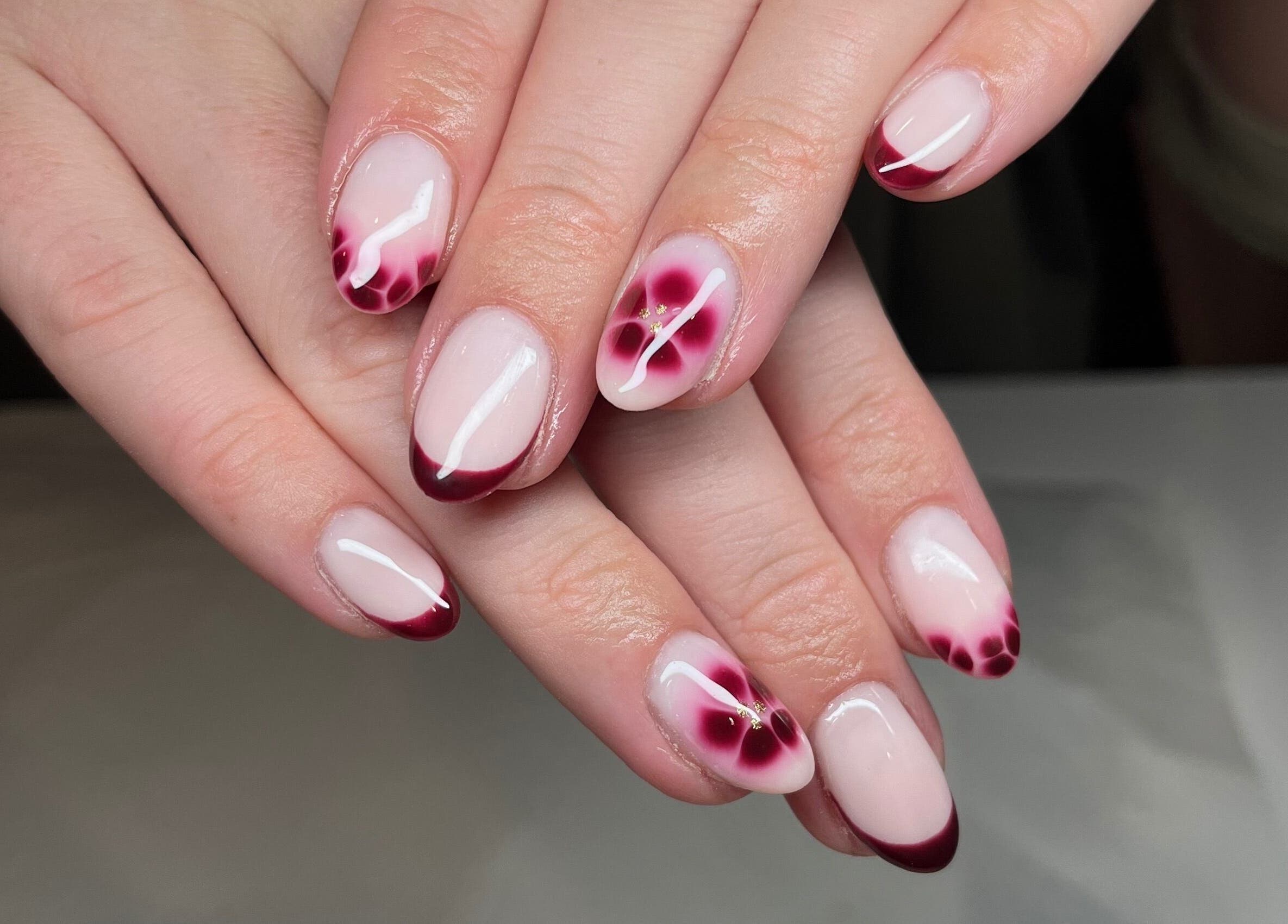 Elegant nail art with red tips at Ella W Smith Beauty in Clayton-le-moors, England, GB.