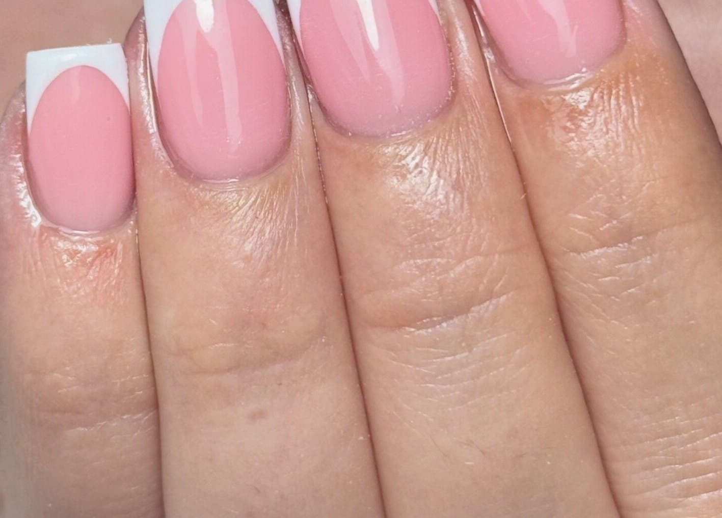 Beautiful gel manicure at Refine Beauty By Meg, Stockport, England, GB, showcasing pink and white nail art.