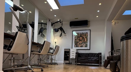 Chic interior of Gianni Hair salon in London, England, GB, featuring modern chairs and stylish decor.
