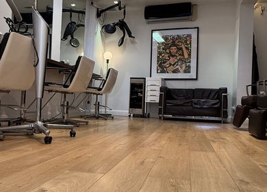Interior of Gianni Hair salon in London, England, GB with stylish chairs and modern decor.