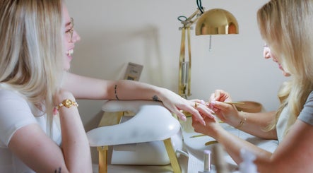 A happy client receiving a manicure at Gloss by Storm in Bowbrook, England, GB. Elegant, serene setting.