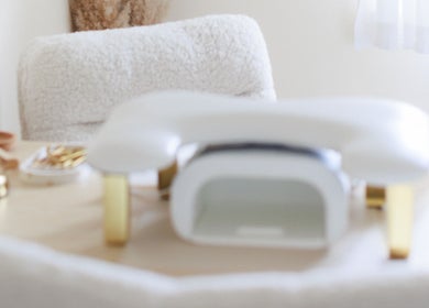 Elegant nail station at Gloss by Storm, Bowbrook, England, GB featuring modern white and gold decor.