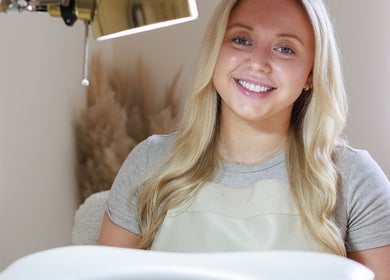 Smiling beauty professional at Gloss by Storm, Bowbrook, England, GB providing expert care.