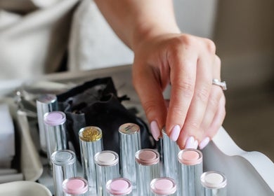 Hand selecting nail polish at Gloss by Storm in Bowbrook, England, GB with elegant manicure options.