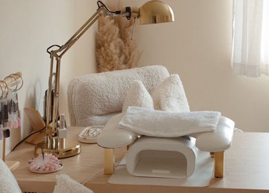 Gloss by Storm's chic nail desk setup in Bowbrook, England, GB with tools and plush seating.