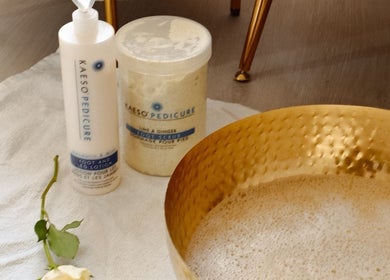 Foot care products and golden basin at Gloss by Storm, Bowbrook, England, GB for a relaxing pedicure experience.