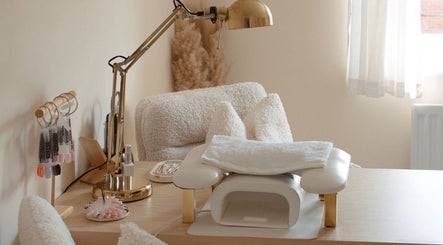 Inviting nail station at Gloss by Storm in Bowbrook, England, GB, featuring plush seating and organized tools.