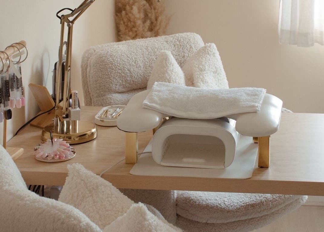 Elegant nail station at Gloss by Storm, Bowbrook, England, GB, featuring plush seating and manicure tools.