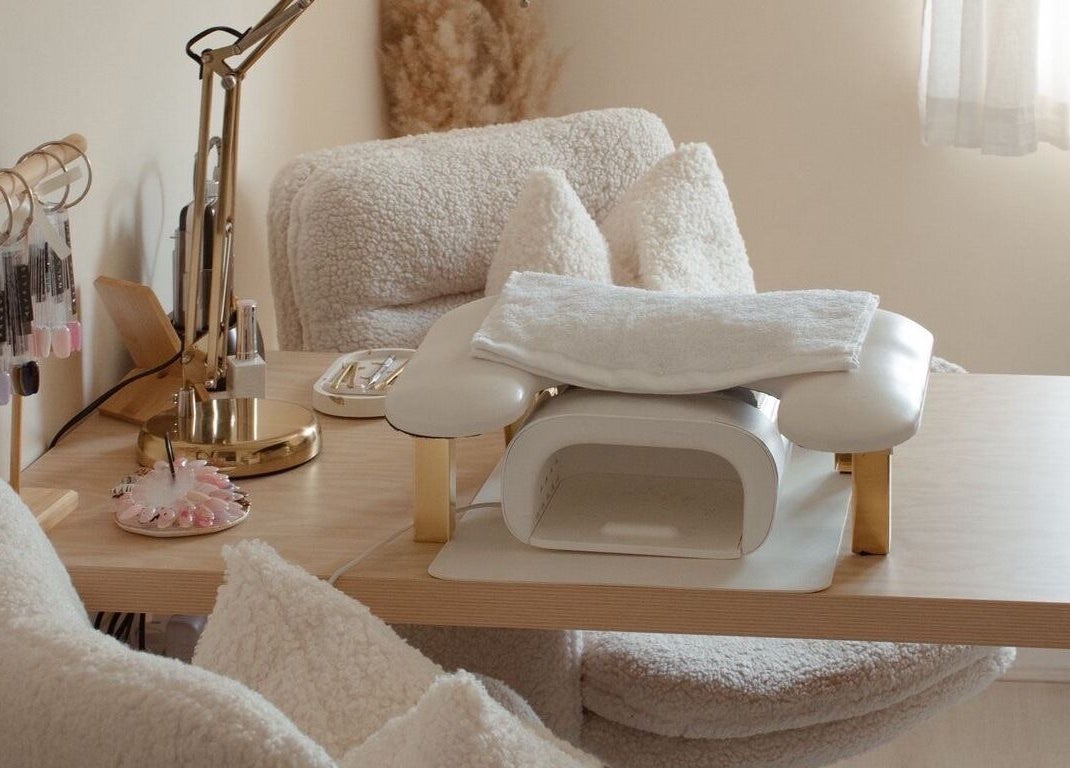 Elegant nail station at Gloss by Storm, Bowbrook, England, GB, featuring plush seating and manicure tools.
