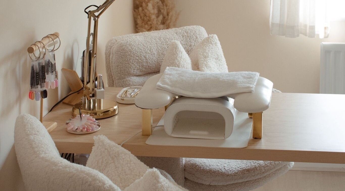 Elegant nail station at Gloss by Storm, Bowbrook, England, GB, featuring plush seating and manicure tools.