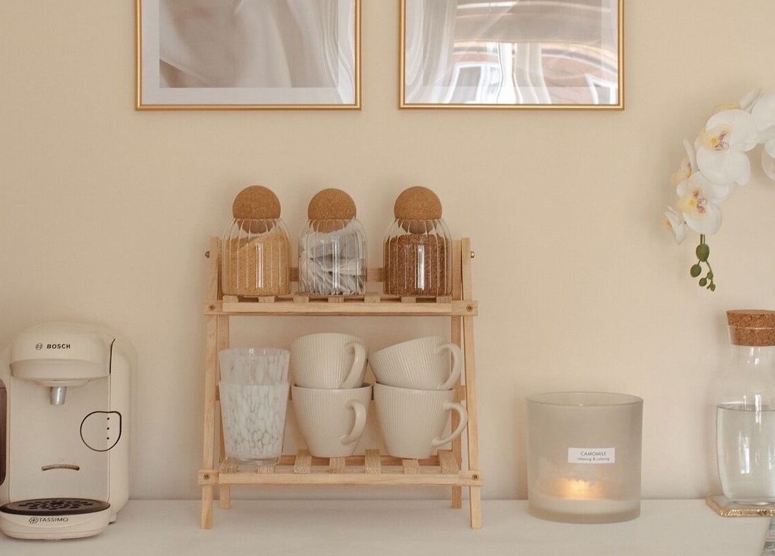 Calming coffee nook at Gloss by Storm, Bowbrook, England, GB with mugs, jars, and orchids.
