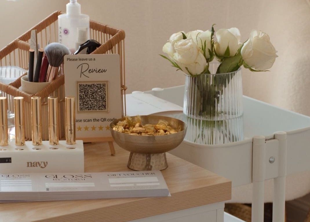 Gloss by Storm's chic beauty setup with flowers and tools in Bowbrook, England, GB.