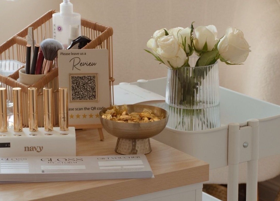 Gloss by Storm's chic beauty setup with flowers and tools in Bowbrook, England, GB.