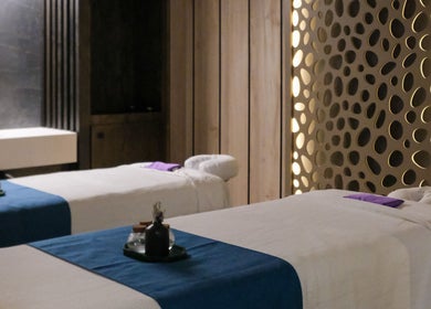 Luxury treatment room at Pamper Valley, Toronto, Ontario, CA with two massage tables and ambient lighting.