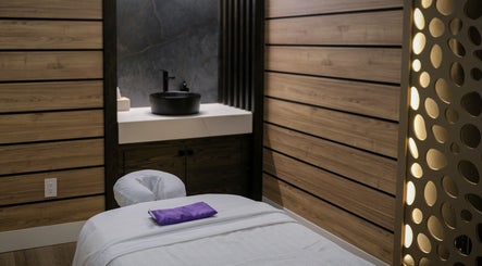 Tranquil spa room at Pamper Valley with wooden accents and massage table, located in Toronto, Ontario, CA.
