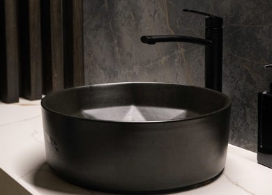 Sleek black sink with soap dispenser at Pamper Valley, Toronto, Ontario, CA, offering luxury ambiance.