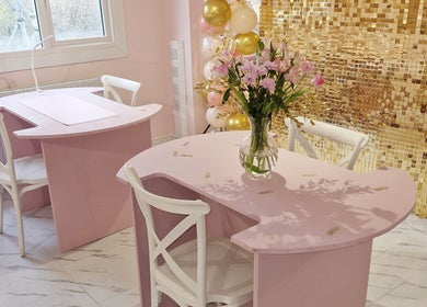 Chic pink nail salon setup at Nordik Aesthetics @ Dahlin, Sandbach, England, GB with flowers and gold decor.