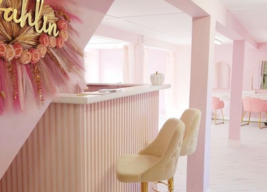 Chic blush and gold interior of Nordik Aesthetics @ Dahlin, Sandbach, England, GB with pink decor and elegant seating.