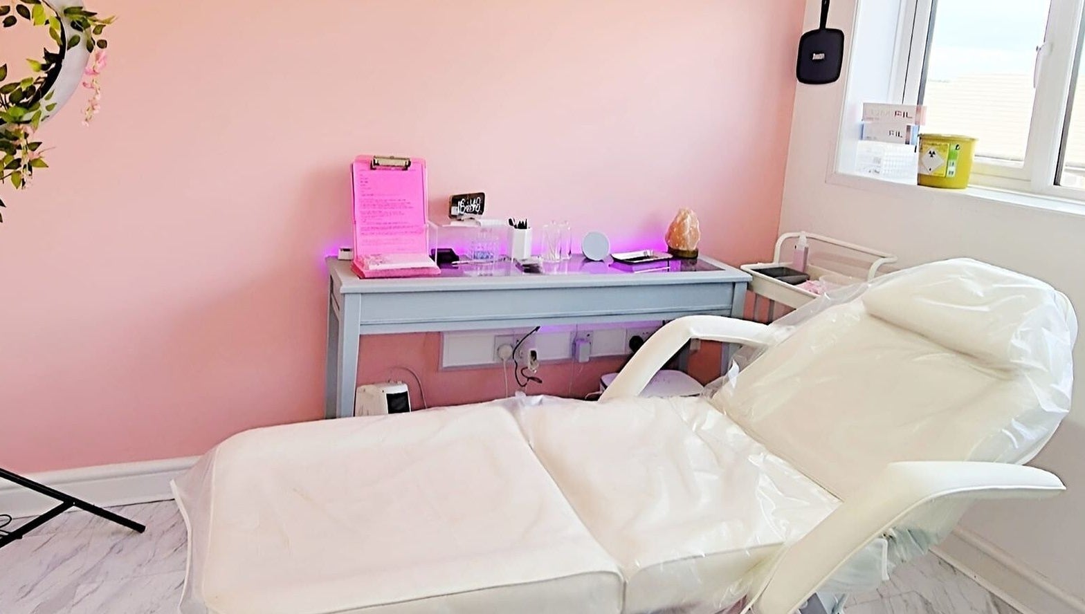 Relaxing treatment room at Nordik Aesthetics @ Dahlin, Sandbach, England, GB with comfortable white chair.
