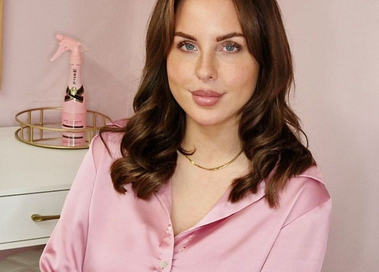 Elegant woman in pink at Nordik Aesthetics @ Dahlin, Sandbach, England, GB. Modern beauty and wellness setting.