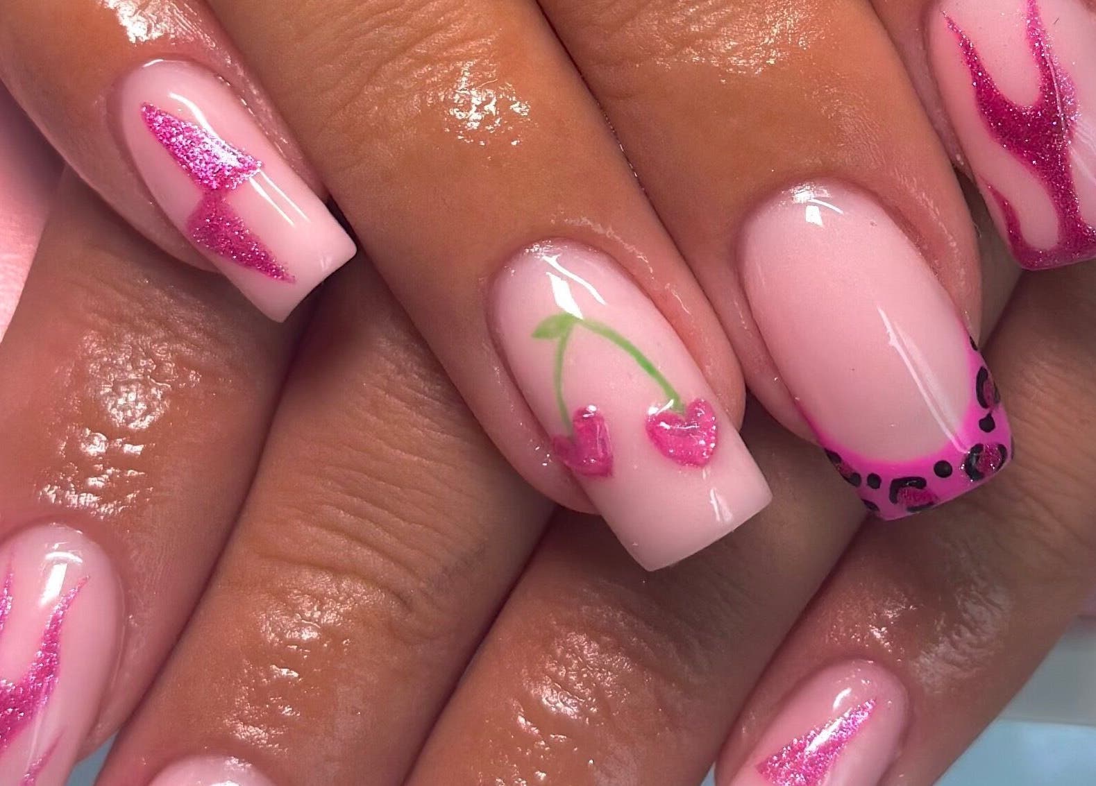 Stylish pink nail art at Nails By CC, Chorley, England, GB. Features cherries and leopard patterns.