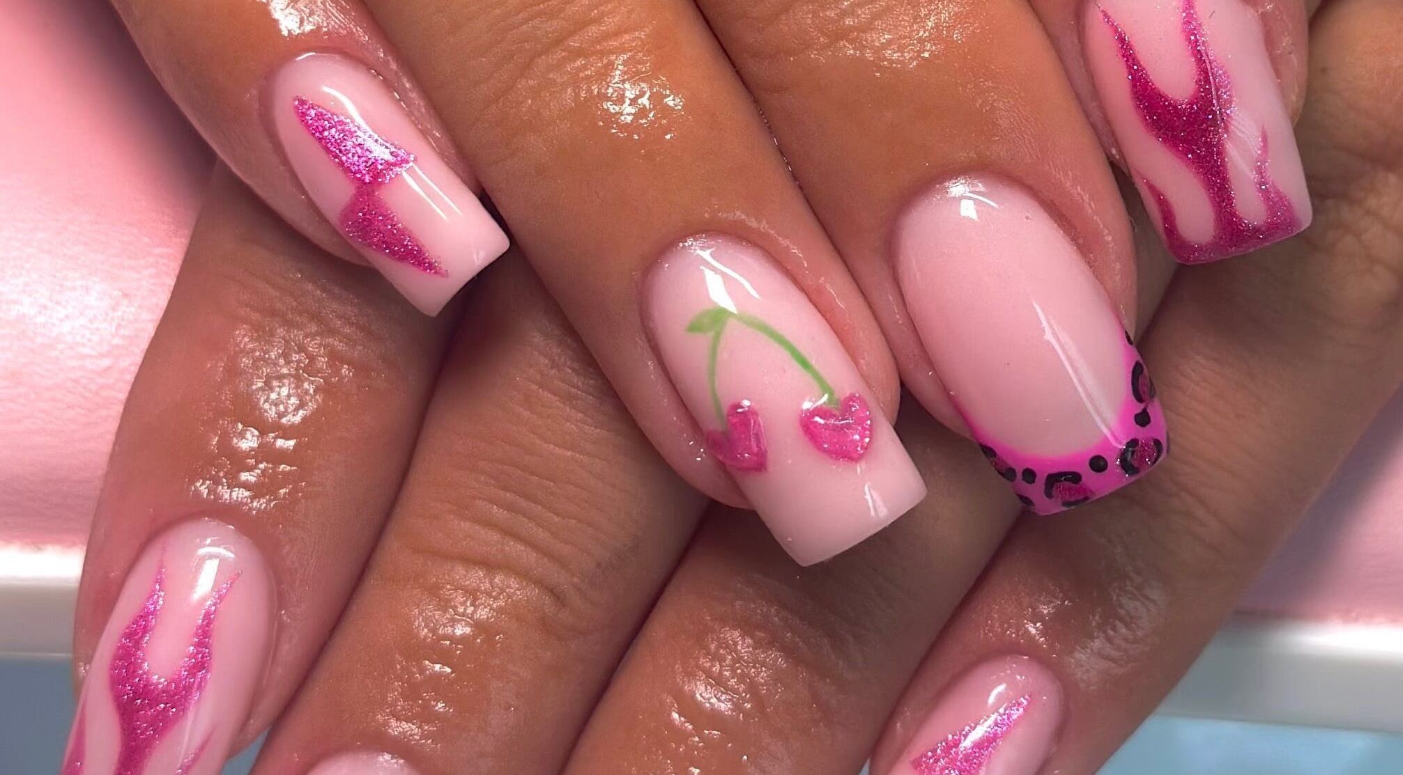 Stylish pink nail art at Nails By CC, Chorley, England, GB. Features cherries and leopard patterns.