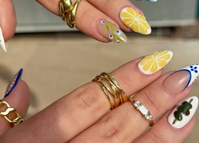Vibrant lemon nail art at Nail Boutique, Denver, Colorado. Exquisite designs with blue and green accents.