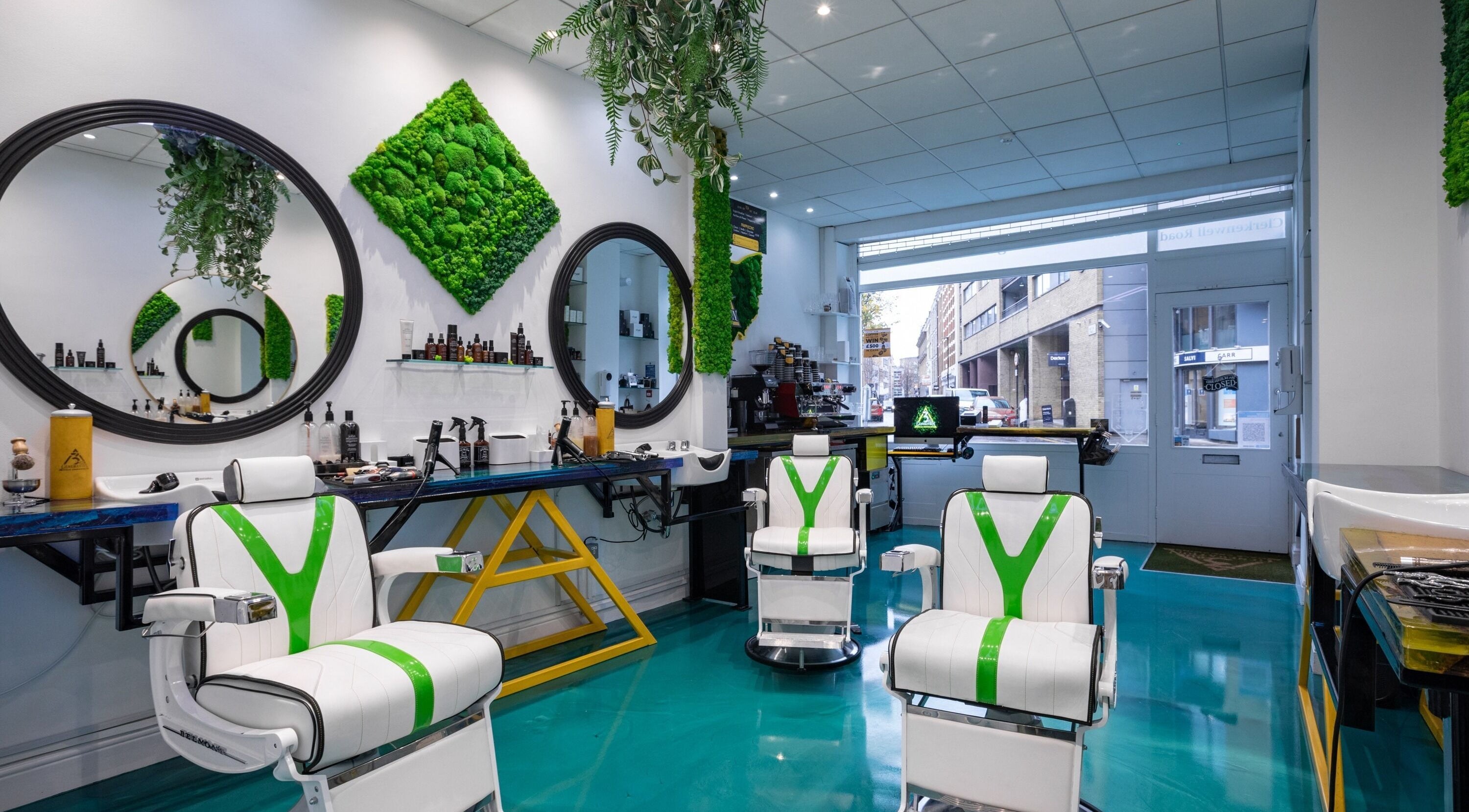 Modern barber chairs at 3rd Generation Grooming, London, England, GB, with lush green decor and sleek design.
