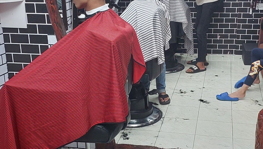 Inside Otai Barber Studio in Seberang Jaya, Penang, MY showing clients at barber chairs.