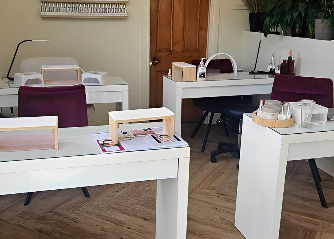 Filly Green salon's cozy nail stations in Douglas, IM, elegantly arranged and warmly lit.