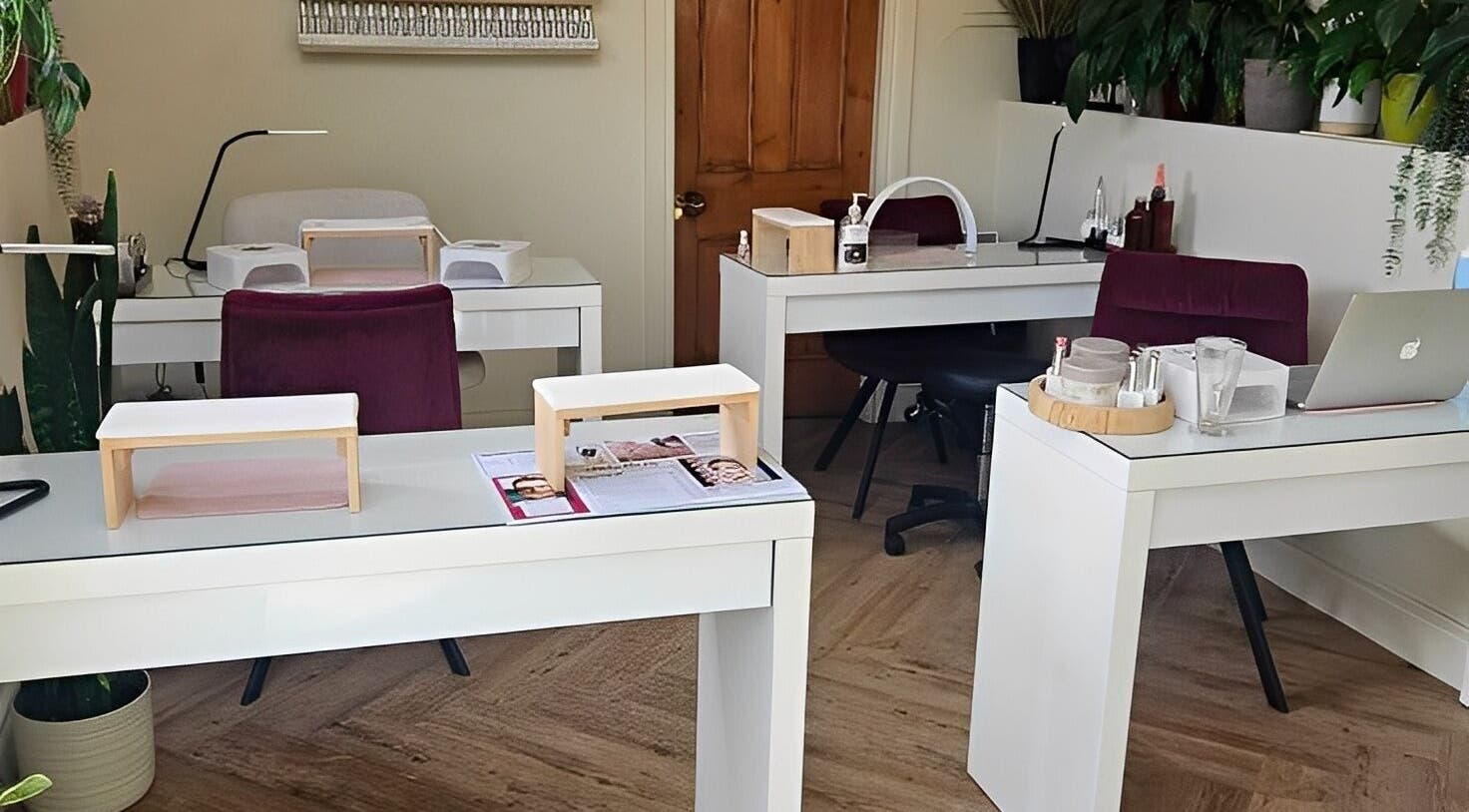 Filly Green salon's cozy nail stations in Douglas, IM, elegantly arranged and warmly lit.