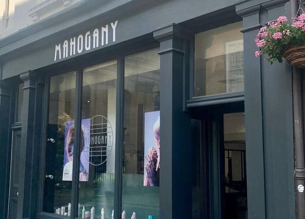Mahogany Hair on Turl Street in Oxford, England with black storefront and signage.