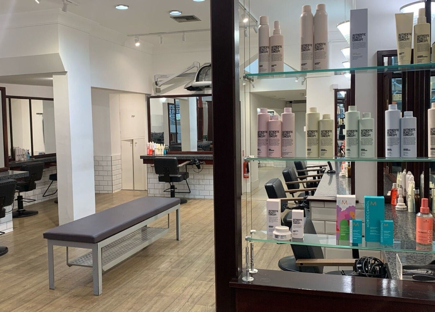 Modern interior of Mahogany Hair - Turl Street in Oxford, England, GB, showcasing styling stations and products.