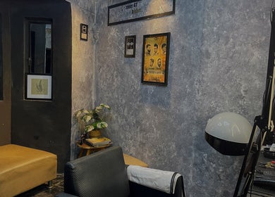 Cozy corner of Room41 Barber with modern decor and framed art in Klang, Selangor, MY.