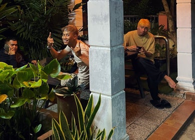 Guests relax in a green outdoor area at Room41 Barber, Klang, Selangor, MY, enhancing the tranquil ambiance.