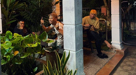 Guests relax in a green outdoor area at Room41 Barber, Klang, Selangor, MY, enhancing the tranquil ambiance.