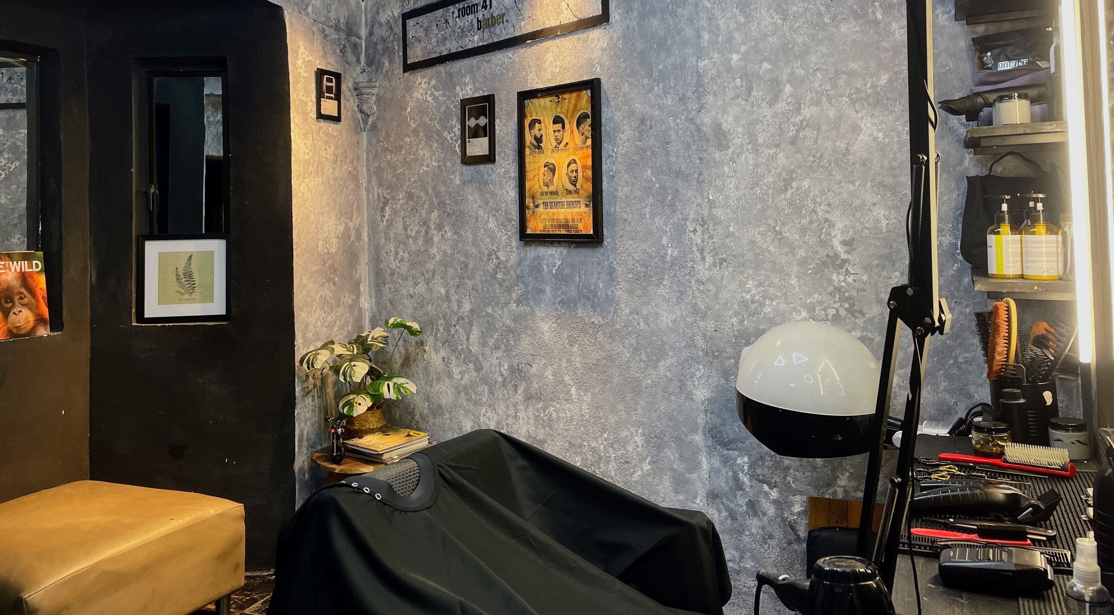 Cozy interior of Room41 Barber in Klang, Selangor, MY featuring a vintage-style setting with salon tools and wall art.