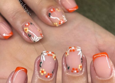 Floral nail art at Aesthetics by Kaylee in Mashishing, Mpumalanga, ZA featuring orange and yellow designs.